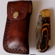 Damascus steel folding knife with leather sheath